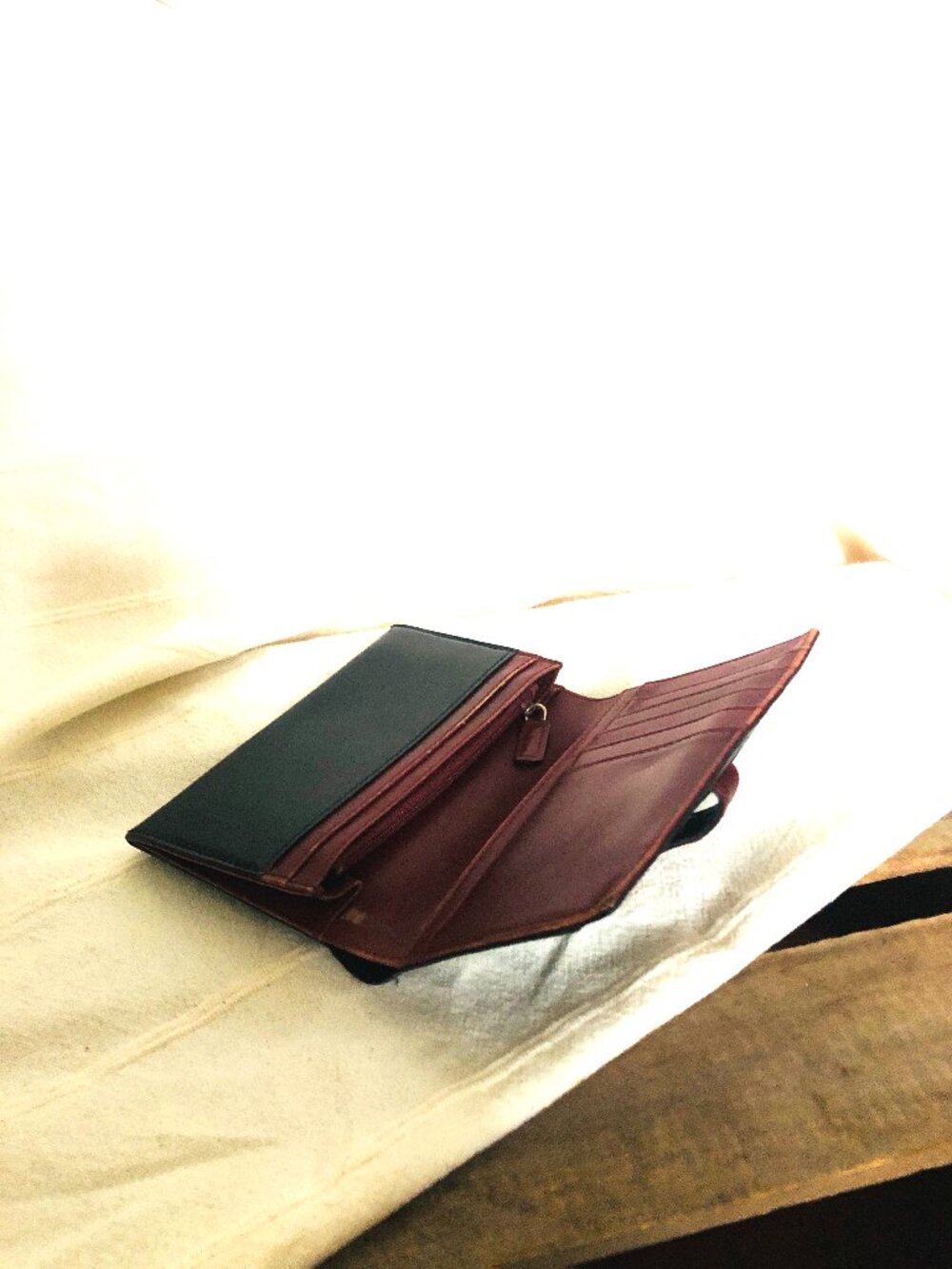 Black leather wallet with cherry-coloured interior